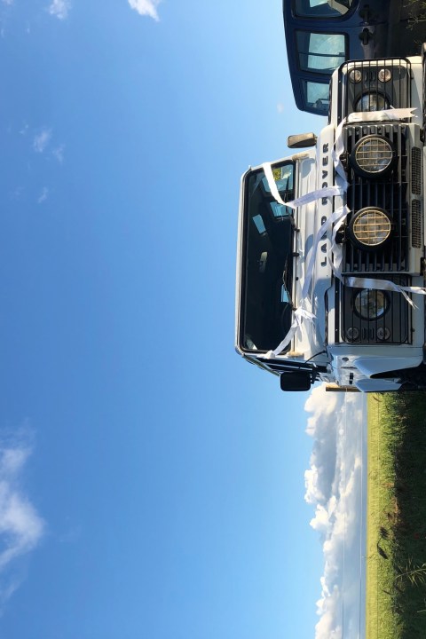 Picture of a white 4x4 Land Rover inside a field